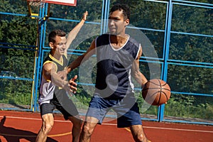 Street basketball players having training outdoor at court.