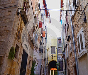 Street with beautiful old colorful buildings in small Adriatic coast city Rovinj, Croatia