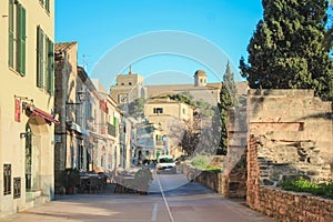 Street behind the city wall in Alcudia, Church of Sant Jaume in the background - Mallorca, Spain