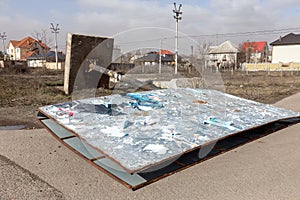 A street billboard is torn down by a strong wind on a stormy day during a hurricane. A strong gusty hurricane wind turned the