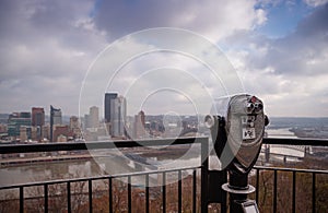 Street binoculars in front of unfocused city. Pittsburgh, Pennsylvania, USA