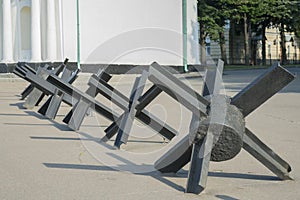 The street is blocked by anti-tank fences. The concept of war and confrontation