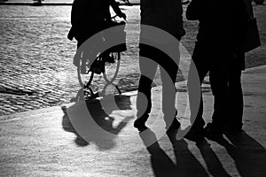 Street bystanders and a cyclist in silhouette