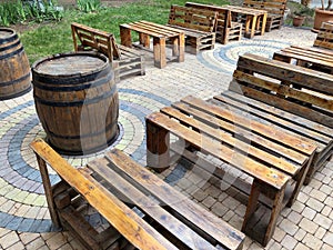 Street cafe or beer pub with wooden furniture, tables and bench made from pallets