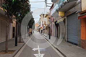 Street in Calella in Catalonia, Spain near Barcelona. Scenic old town with sand beach and clear blue water. Famous tourist