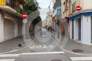 Street in Calella in Catalonia, Spain near Barcelona. Scenic old town with sand beach and clear blue water. Famous tourist