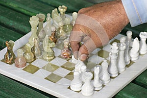 Street chess game. The grandmaster makes a pawn move. Dedicated to International Chess Day