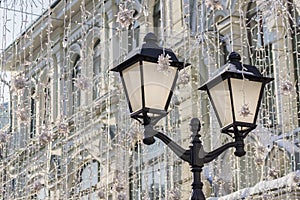 Street christmas decoration. White garlands above the street