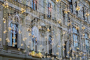 Street christmas decoration. White garlands above the street, holoday background