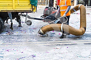 Street cleaner with industrial vacuum cleaner. Municipal cleaning service, clean streets.