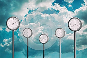 Street clock on the background of the cloudy sky. Showing different times. Planning concept. Time management. Lack of time.