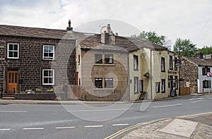 Street corner in the old village centre in mytholmroyd west yorkshire with traditional stone houses and the shoulder of mutton pub