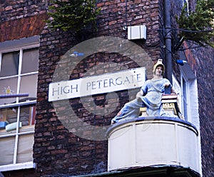 Street corner sign and statue in York