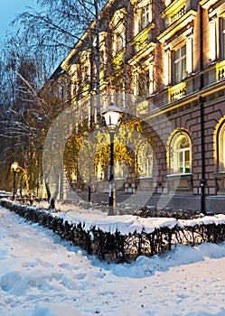 Street covered with snow at night old building