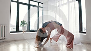 Street dancing - a young woman dances plastically in a white room