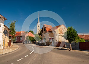 Street of Dej city, Cluj County, Transylvania, Romania. Gothic Reformed-Calvin Church on background photo