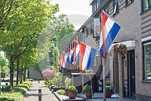 Street with dutch flags hanging outside on `Kingsday`