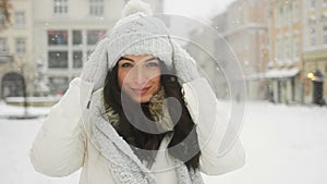 Street emotional portrait of young beautiful woman in city Model looking at camera. Lady wearing stylish classic winter