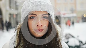 Street emotional portrait of young beautiful woman in city Model looking at camera. Lady wearing stylish classic winter