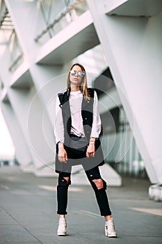 Street fashion concept - pretty young slim woman in rock black style