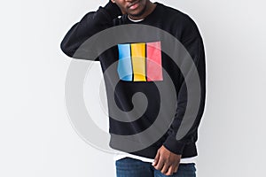 Street fashion concept - Studio shot of young handsome African man wearing sweatshirt against white background, close-up