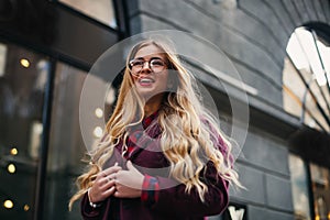 Street fashion concept. Young beautiful model in the city. Beautiful blonde woman wearing sunglasses portrait of a young girl
