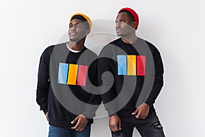 Street fashion and friendship concept - Two happy african american young men in black stylish sweatshirts.