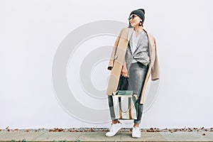 Street fashion look. Female multilayered outfit for autumn days photo