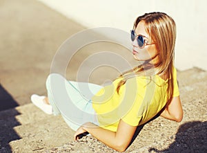 Street fashion portrait trendy young blonde woman in sunglasses