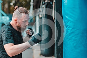 Street Fighter Boxing in Punching Bag Outdoors