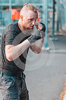 Street Fighter Boxing in Punching Bag Outdoors