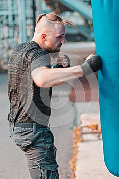 Street Fighter Boxing in Punching Bag Outdoors