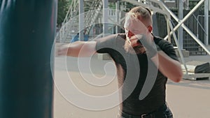 Street Fighter Boxing in Punching Bag Outdoors