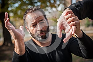 Street fighting self defense technique against holds and grabs