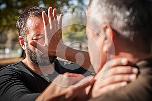 Street fighting self defense technique against holds and grabs