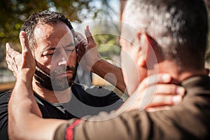 Street fighting self defense technique against holds and grabs