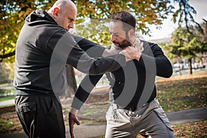 Street fighting self defense technique against holds and grabs