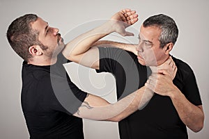 Street fighting self defense technique against holds and grabs