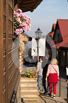 Street, flowers, lantern in beautiful cozy small town Lanckorona, Poland