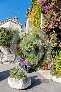 Street with flowers in the old village , France.