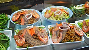 Street food in Asia, traditional national food in Asia. night market, exotic products and seafood, outdoor cooking for