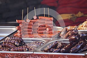 Street food with assortment of grilled sausages.