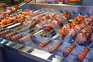 Street food. Automatic stainless steel grill grills skewers on skewers. Fried meat. Cooking street food