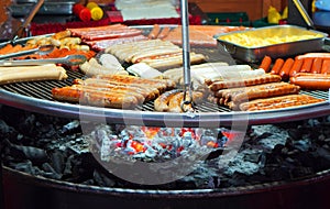 Street food background with assortment of grilled sausages