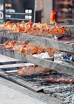 Street Food. Chicken On Skewers Cooking Over Charcoal Grill