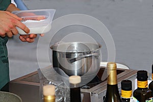 Street food exhibition: The chef prepares a plate of spaghetti