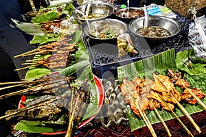 Traditional grilled fish and chicken sticks. Street food, Laos. photo