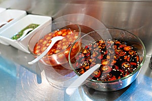 Street food market in Asia. Bowls with hot sauces of various types