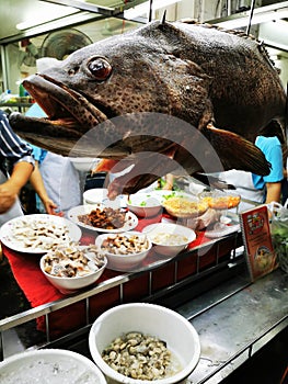 The street food in the night market in Bangkok selling fresh seafood fish and boil rice