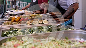 Street Food Seller Weighs Barbecue, Fried Vegetables on an Electronic Scale. 4K